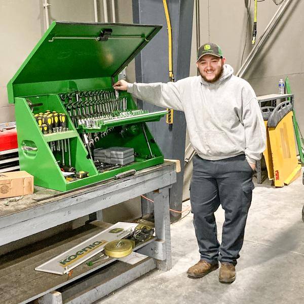 A Koenig Equipment technician intern at his toolbox in the service shop
