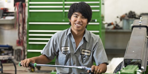A Koenig Equipment service technician with a torque wrench in the shop