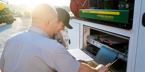 A Koenig Equipment mentor and intern working from a service truck