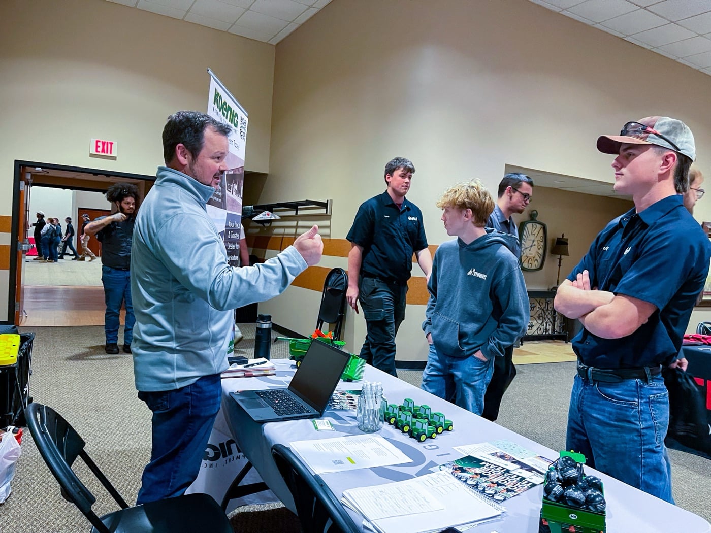 A Koenig Equipment team member talking with students at the Koenig booth during a college career fair